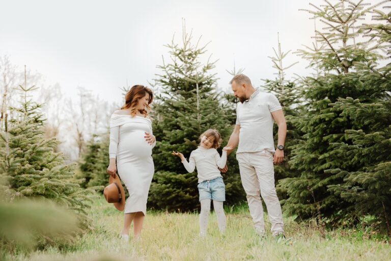 Famille enceinte avec enfant dans champ de sapins, photo de grossesse en nature près d'Annemasse