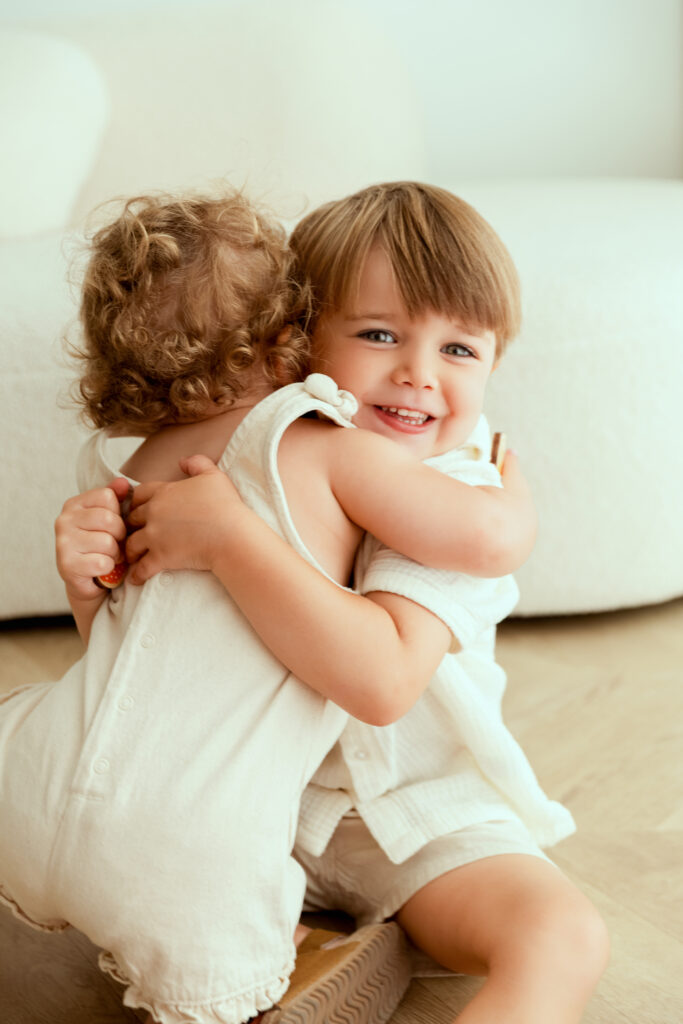 Two children hugging, sibling session