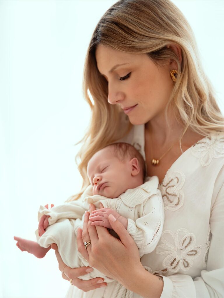 Mother holding her sleeping newborn